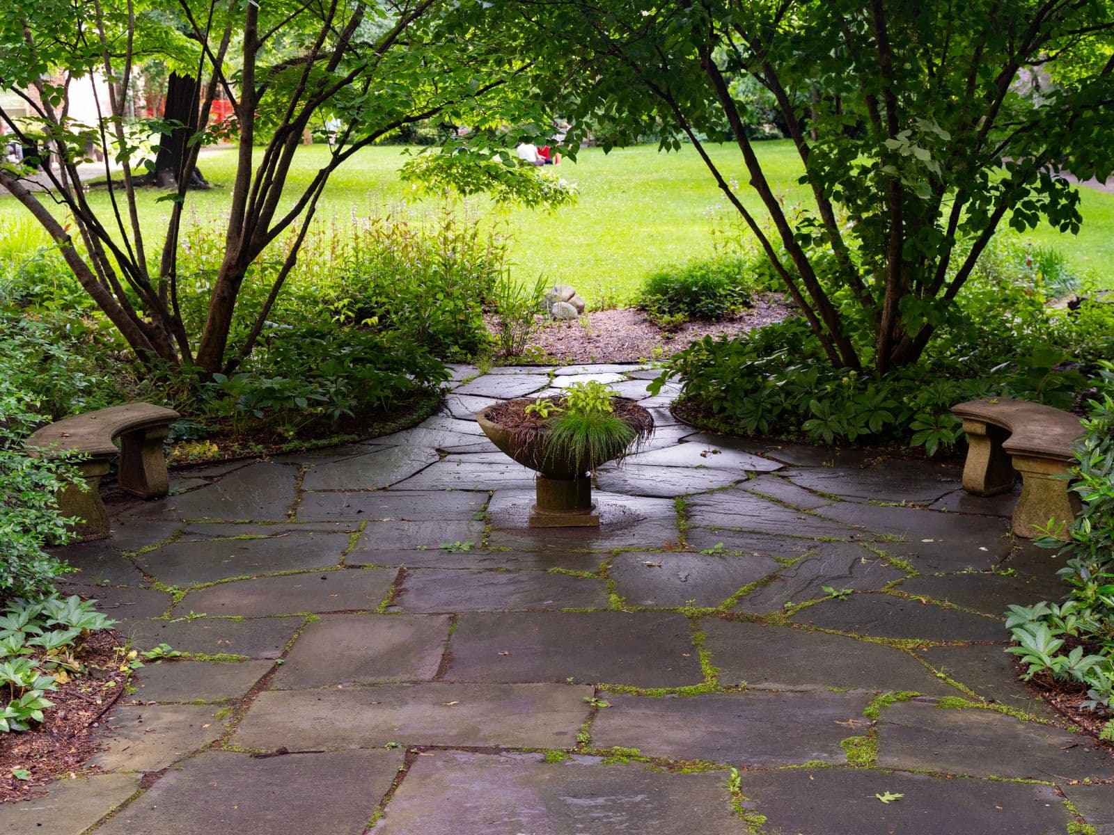 Flagstone patio shaded by mature trees