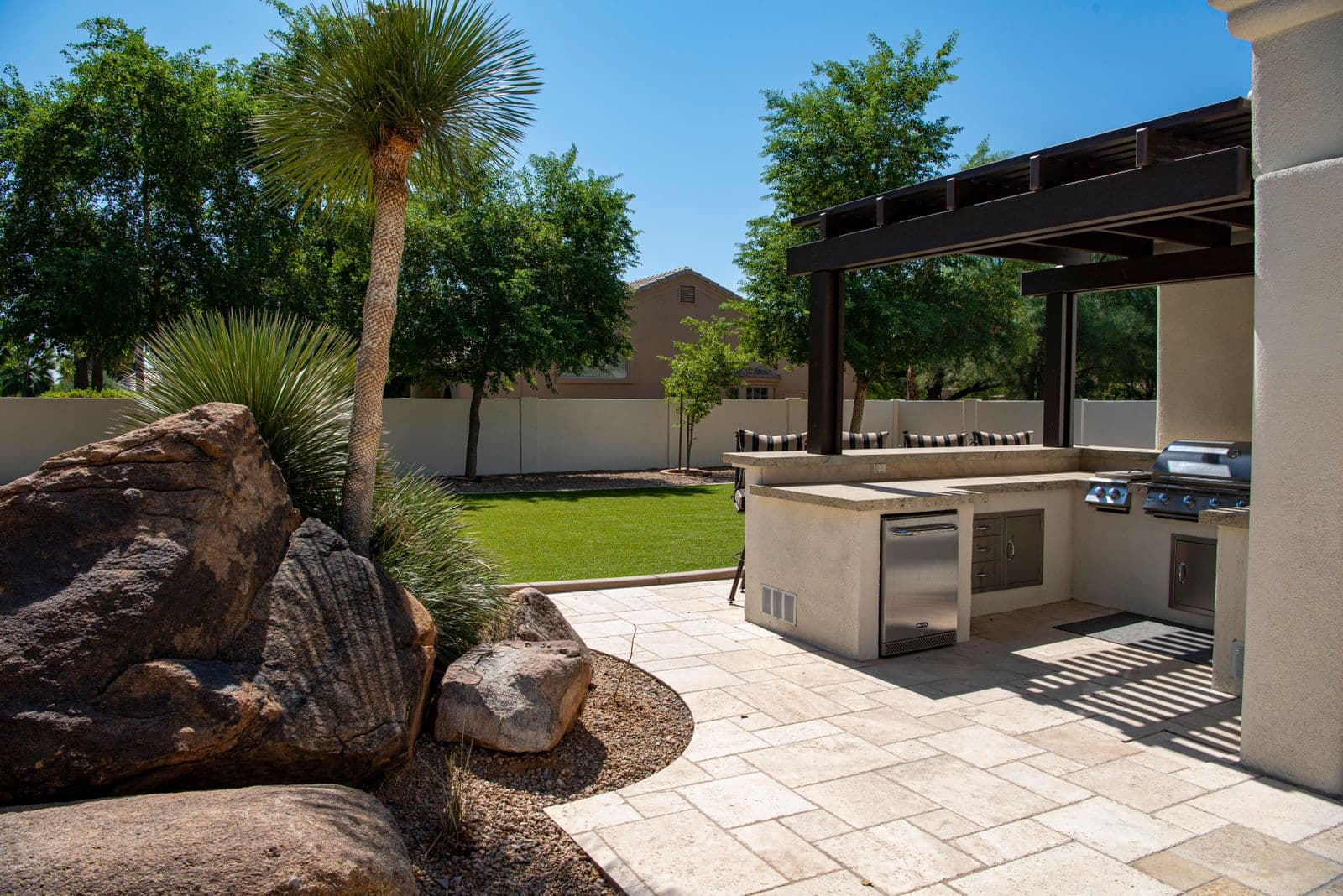 Covered outdoor kitchen on a stone patio